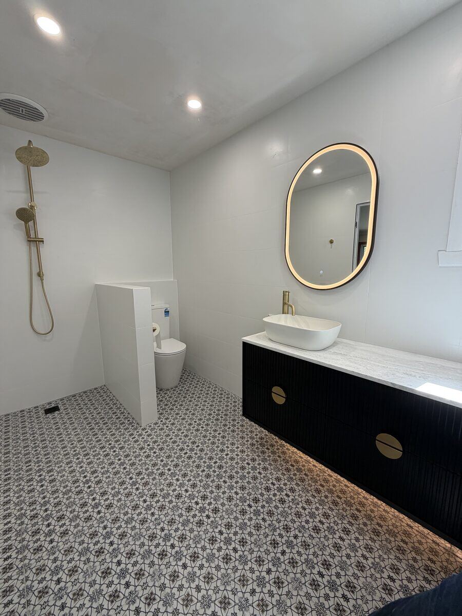 Open plan bathroom with patterned tiles